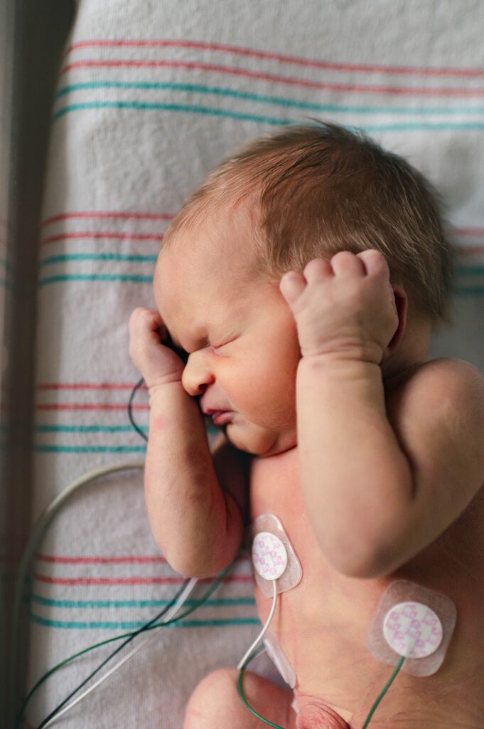 A Houston TX newborn is photographed during a fresh 48 session at Memorial Hermann Memorial City Medical Center