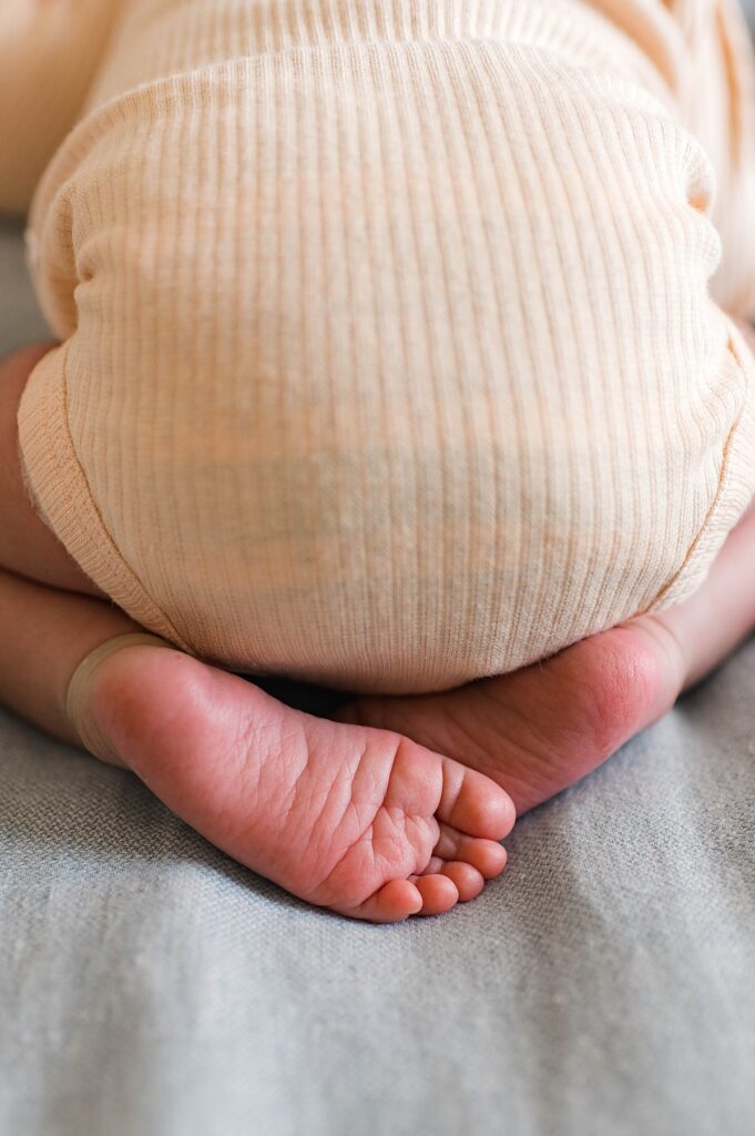 A close up of newborn feet during an in-home photoshoot in the Bridgeland area of Cypress, TX is pictured.