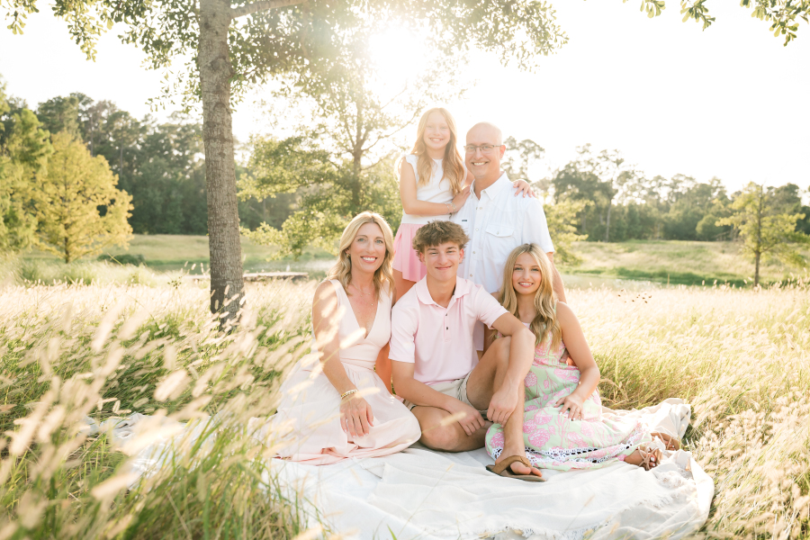 A family of five poses for an outdoor spring Cypress photography session with a Houston family photographer.