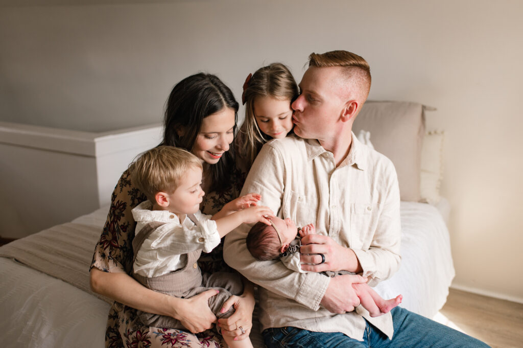 A Cypress TX family of 5 (including their newborn daughter) photoshoot with Mel B photo is shown to highlight the importance of including variety with prints, solids, and textures when planning outfits for family photos.