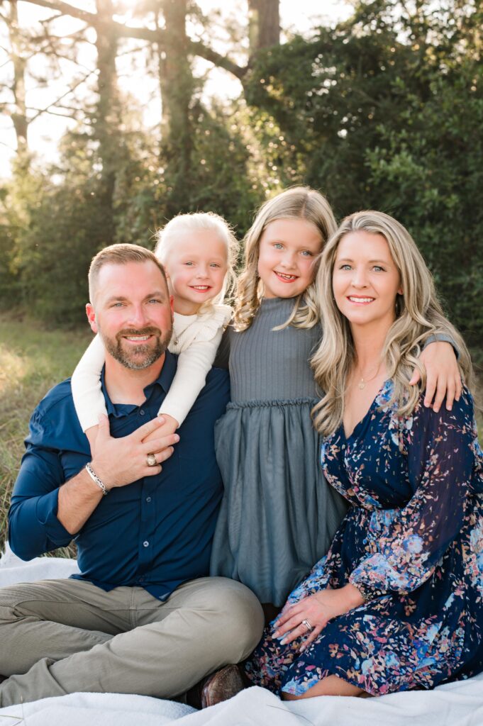 Cypress, TX family of four poses for their outdoor family photos