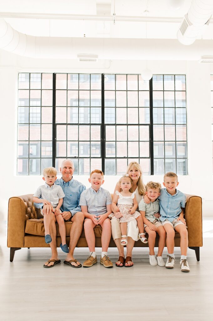 An extended family session is photographed in a Houston portrait studio 