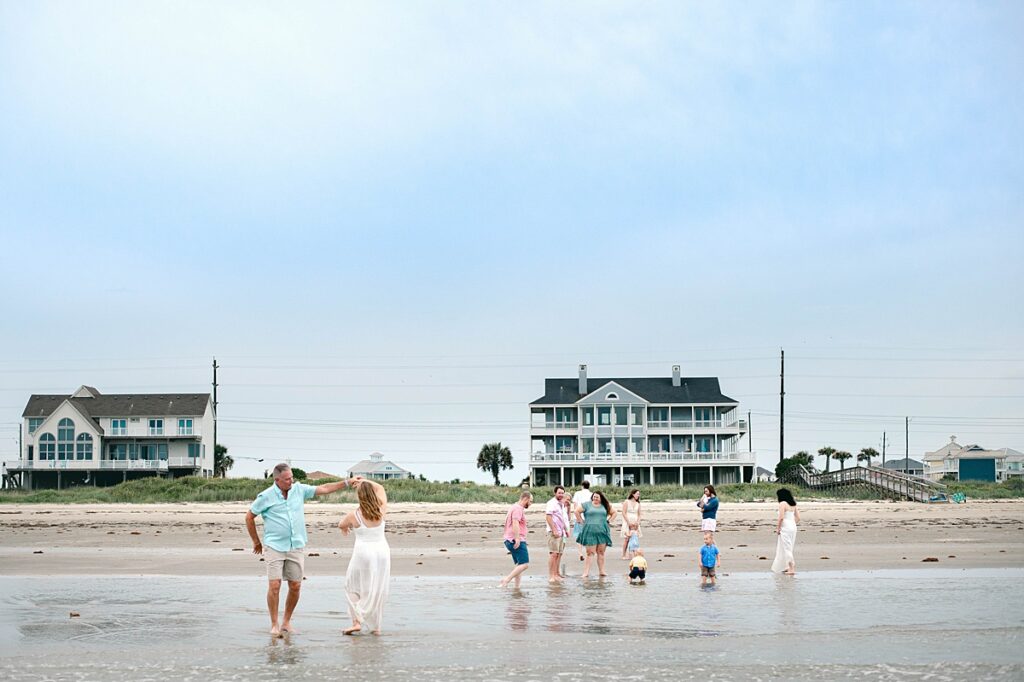 A Texas family is photographed playing on the shore of a beach near Houston TX