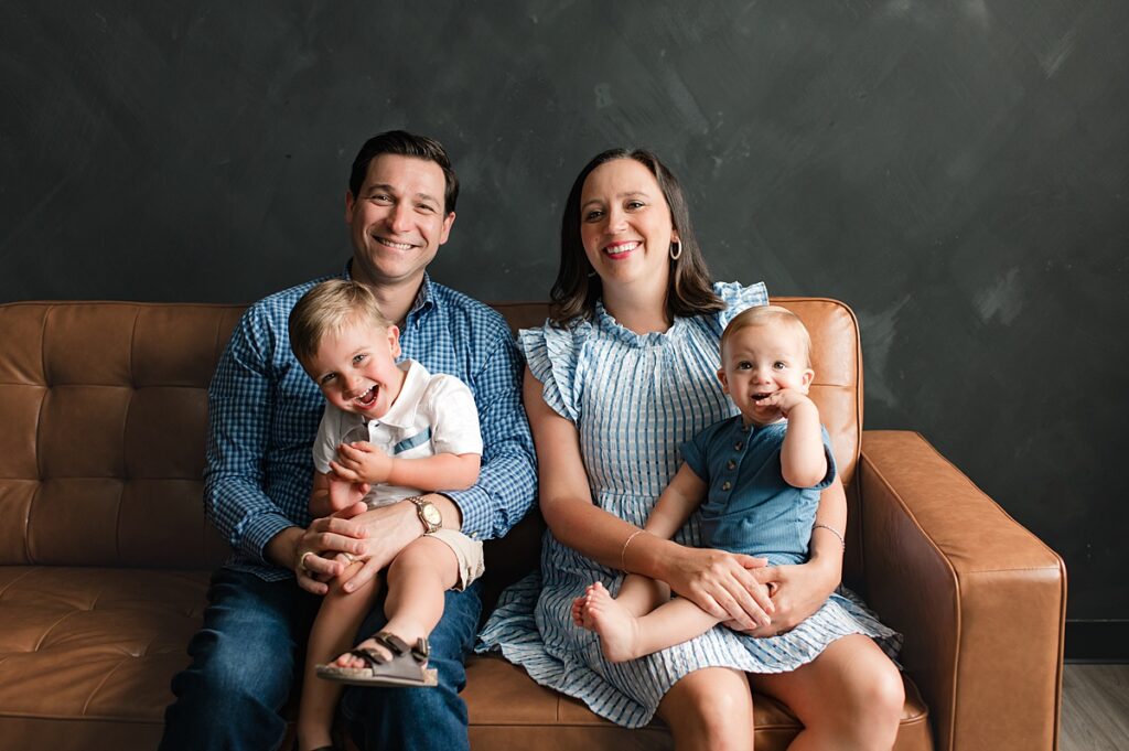 A family of four is photographed in a natural light studio during a Houston family photo shoot with Mel B Photo