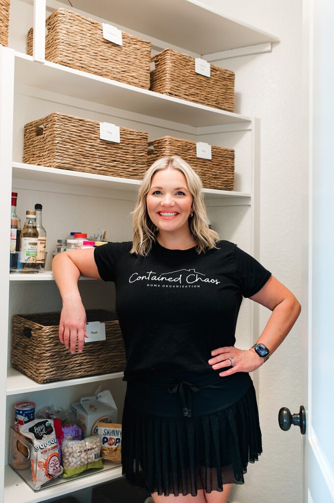 A professional organizer in Houston TX is pictured in a home pantry she organized 