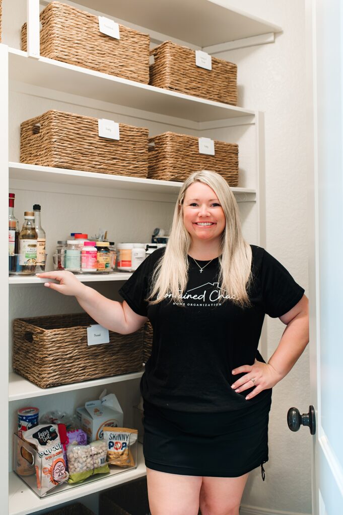 A professional organizer in Houston TX is pictured in a home pantry she organized 