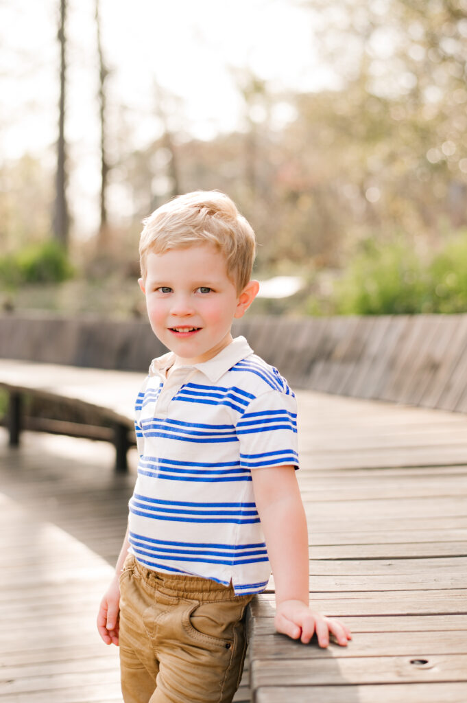 A young boy is photographed at Memorial Park during a family session by Mel B Photo, shown to depict some of the photographer's favorite places to take photos in Houston 