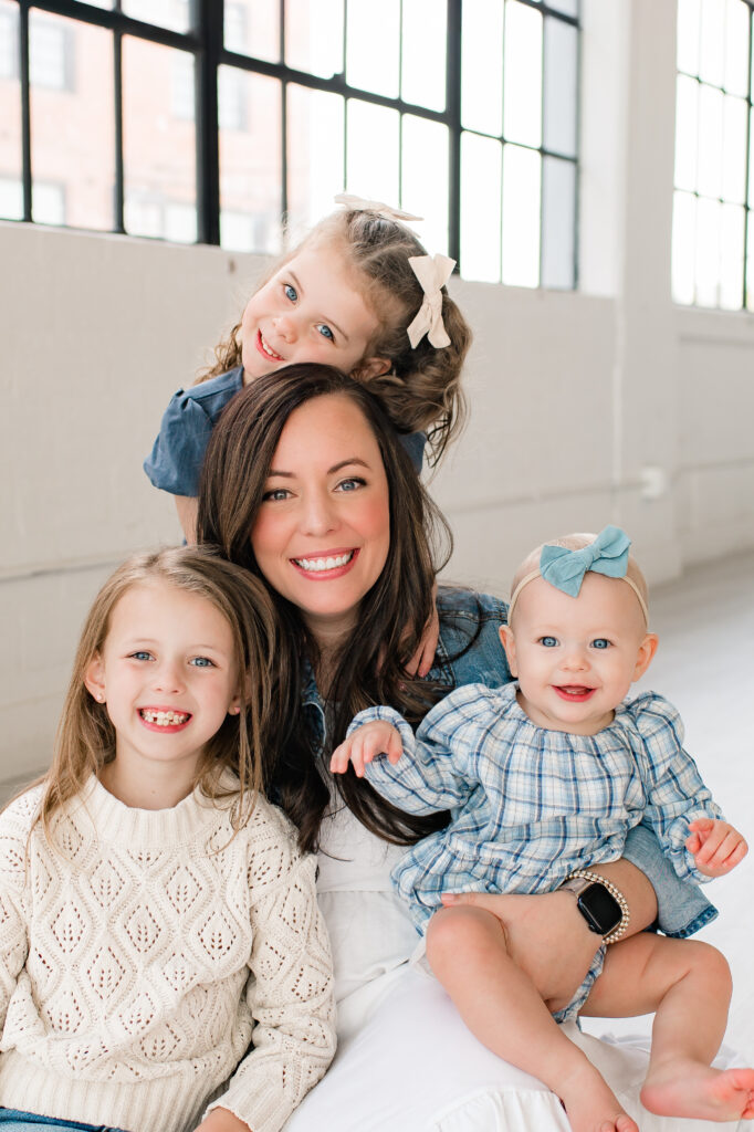 A mother is photographed with her three daughters inside one of the photo studios in Houston TX during a family photoshoot 