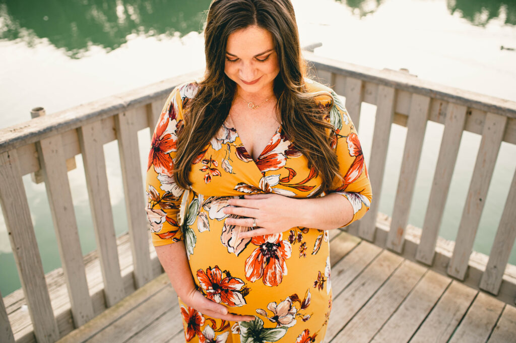 An expectant mother holds her baby bump in an image taken at Mary Jo Peckham Park, one of the best photo locations in Houston