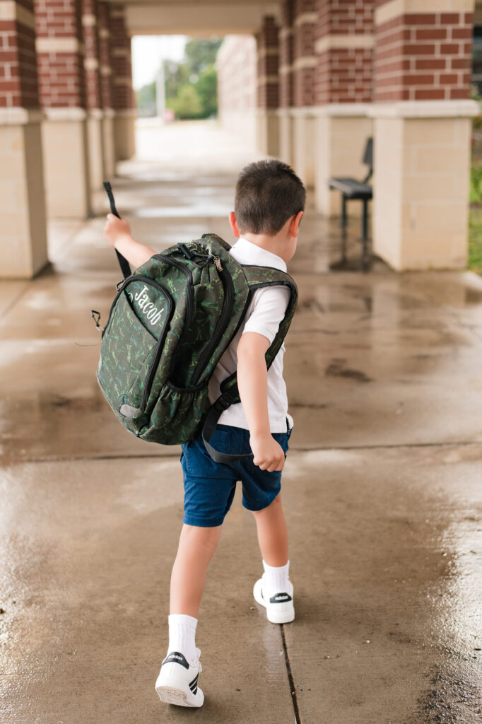 A young boy wears his new backpack in kindergarten back to school photos taken by child photographer houston, Mel B Photo 