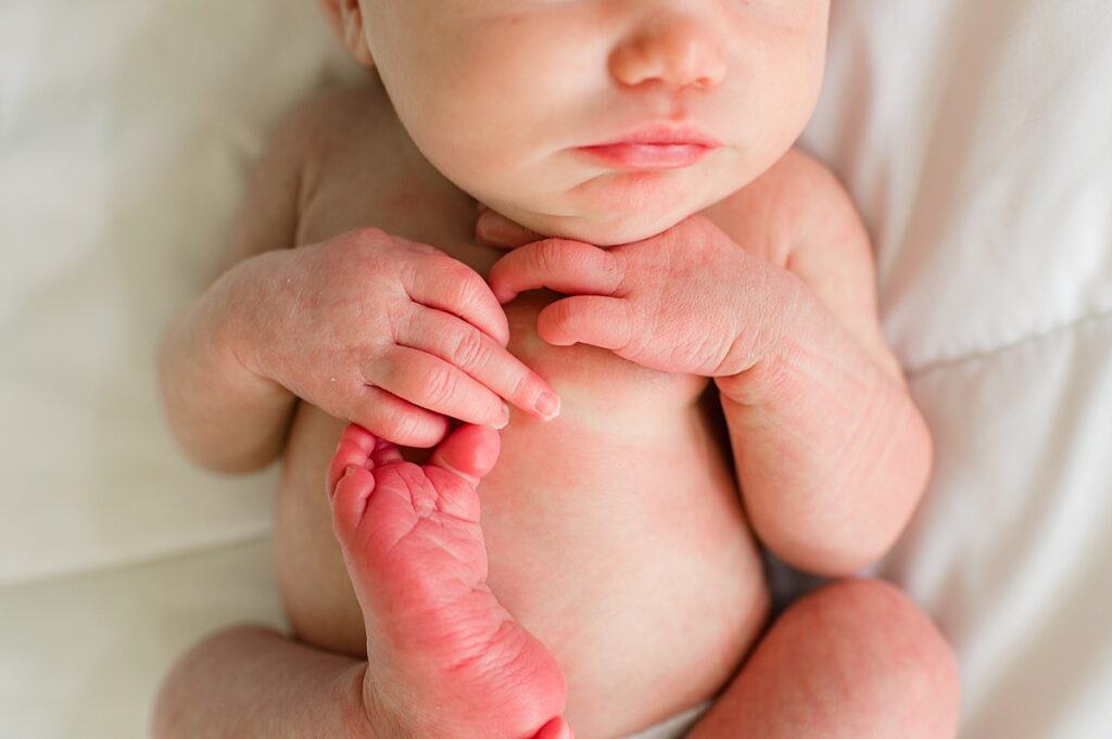 A newborn baby is photographed during an in-home Houston newborn session with local sleep trainer 
