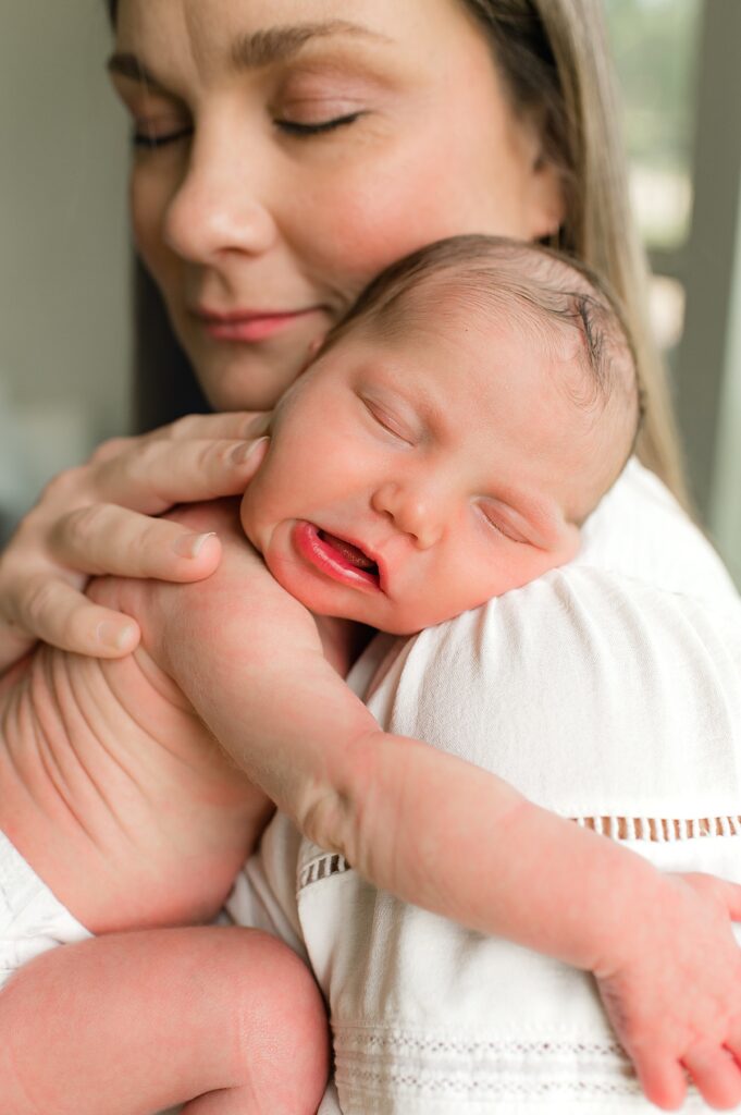 Houston sleep trainer, Lauren Alyers, snuggles her newborn daughter during an in-home photoshoot with Mel B Photo 