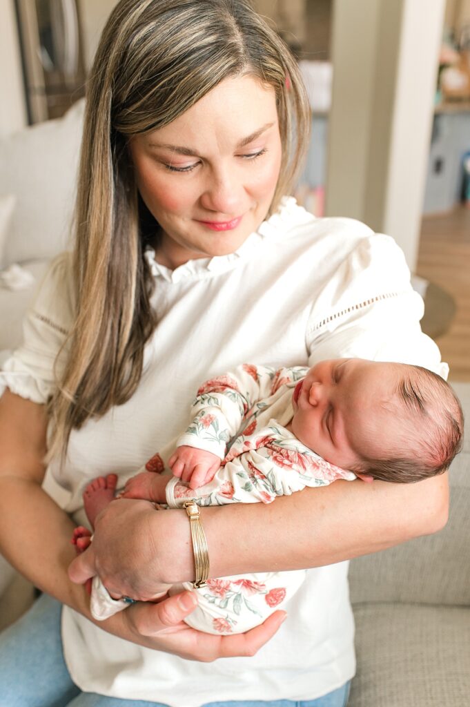 Houston sleep consultant, Lauren Ayers, cradles her newborn daughter during a newborn photoshoot with Cypress newborn photographer, Mel B Photo 