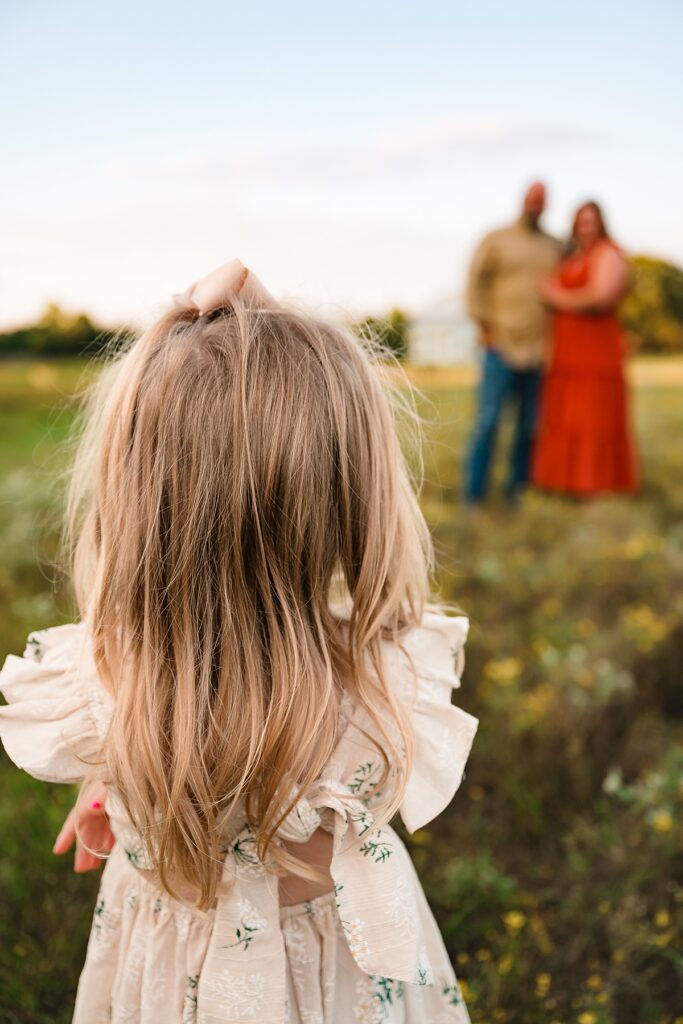 A young girl is photographed in a family photo taken by a Cypress photographer