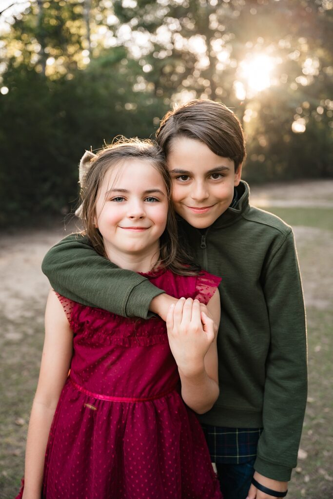 Siblings pose during family portraits houston tx