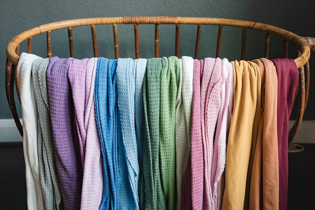 A  collection of colorful newborn wraps belonging to a newborn photographer in the woodlands tx