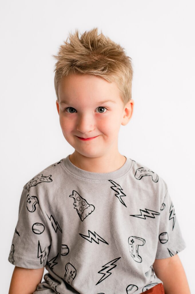 A young boy poses for a Houston school portrait