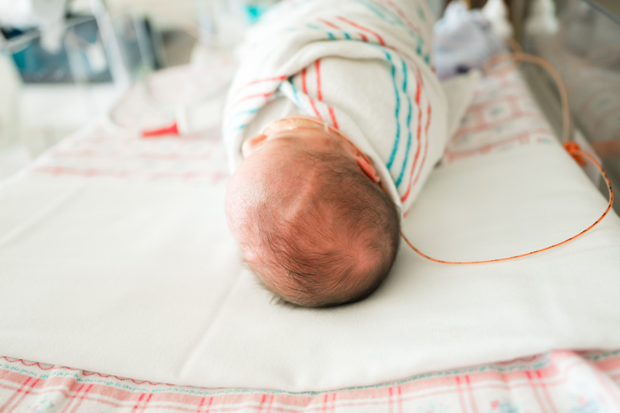 A newborn baby girl is swaddled in a NICU Houston TX