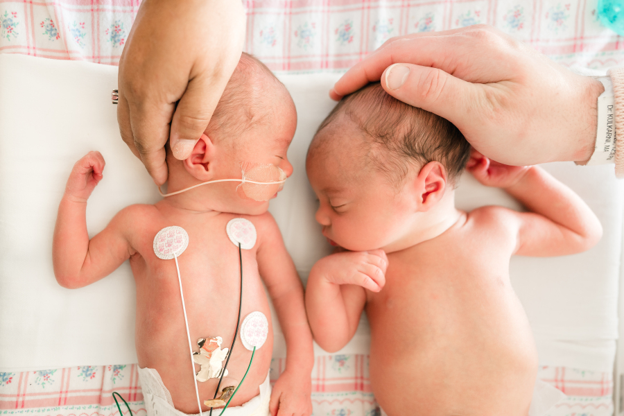 Twin girls are photographed during a fresh 48 photoshoot in a nicu houston tx