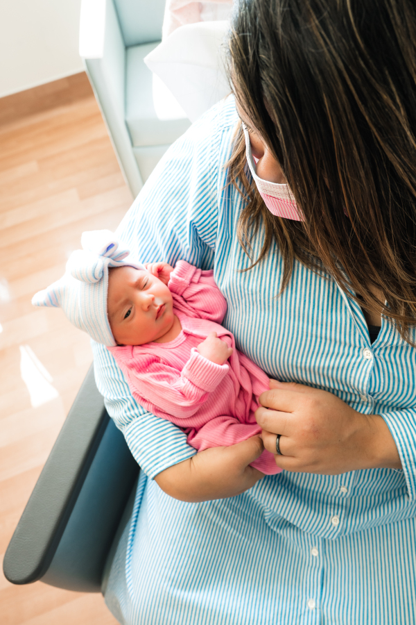 A mother holds her newborn daughter in a nicu houston tx