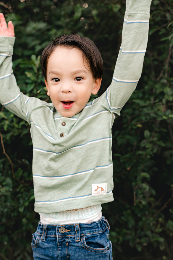 A toddler boy poses for a photo taken by Cypress Texas family photographer, Mel B Photo