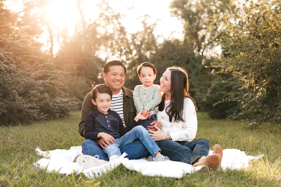 A family photo showcases a Cypress TX family of four taken in a Bridgeland community park 