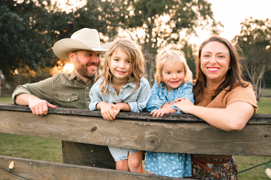 A photo of a family of four taken during a golden hour Houston family photo session is shown in a guide for family fun things to do in Houston TX. 