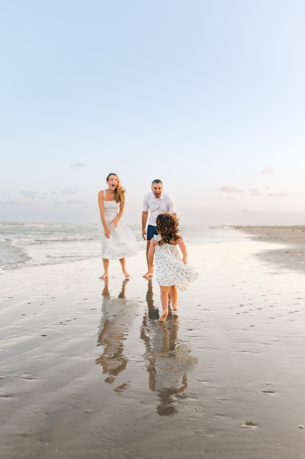 A young girl runs to her parents on the beach in a photo featured in a guide about fun family things to do in houston tx. 