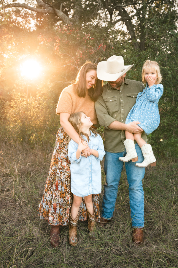 A family of four is photographed at golden hour in an image taken for a guide to family fun things to do in houston tx. 