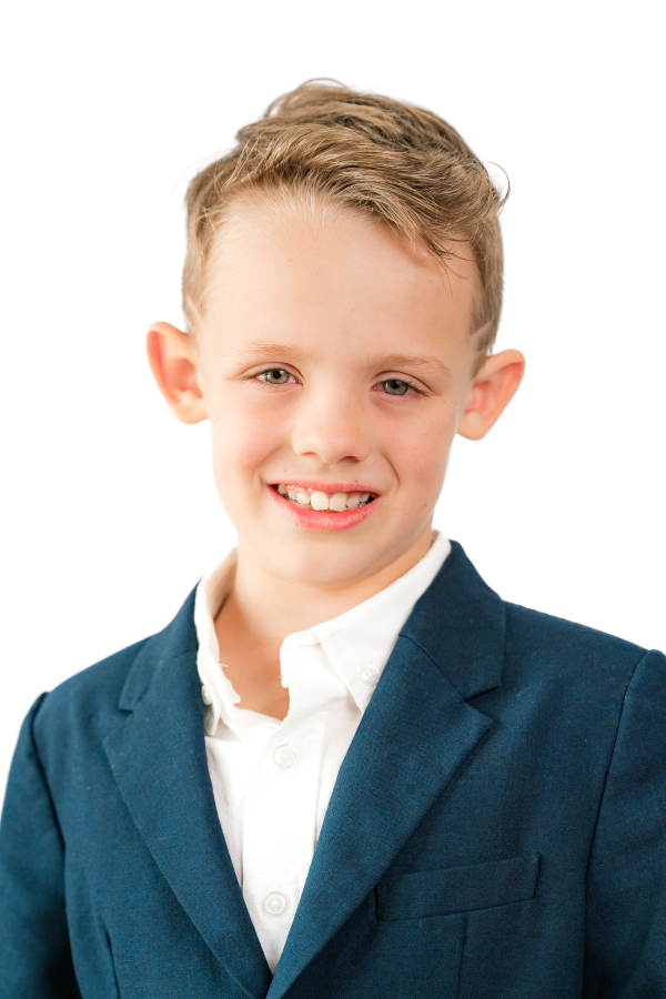 A young boy smiles for Houston school pictures.